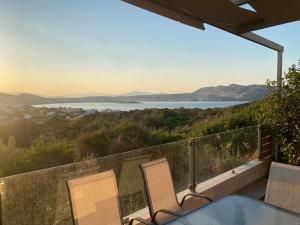 a view of the water from the balcony of a house at EUPHORIA Pool Villa in Porto Rafti