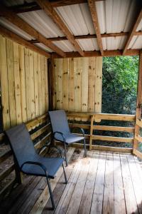 two chairs sitting on a deck in a cabin at Fisherman's Countryside Escape in Scottsboro