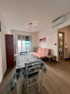 a living room with a table and a couch at Chicco & Didi in Rapallo