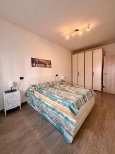 a bedroom with a large bed and a night stand at Chicco & Didi in Rapallo
