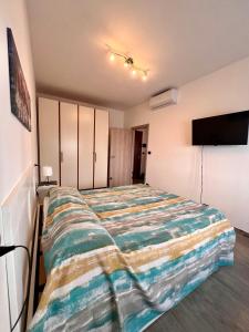 a bedroom with a bed and a flat screen tv at Chicco & Didi in Rapallo