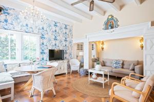 a living room with blue and white wallpaper at Van der Valk Hotel Suites S'Agaró in Sant Feliu de Guíxols