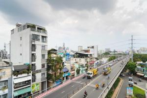 a city street with cars and vehicles on the road at Collection O Eva Hotel District 8 Near Ben Thanh Market in Ho Chi Minh City