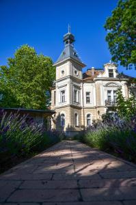 an old building with a clock tower on top of it at Jókai Villa in Siófok