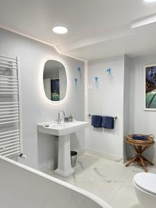 a white bathroom with a sink and a toilet at Domaine des Encourdoules in Vallauris +57 photos