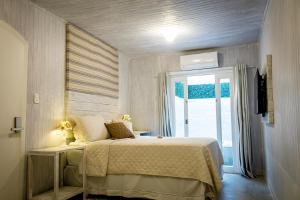 Cama ou camas em um quarto em Pousada Hospedaria215