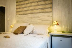 Cama ou camas em um quarto em Pousada Hospedaria215