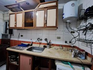 a kitchen with a sink and a counter top at شقة مفروشة 5 سراير في كامب شيزار in Kafr ‘Ilwān