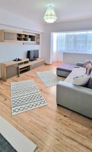 a living room with two couches and a television at Apartament Niki in Mangalia