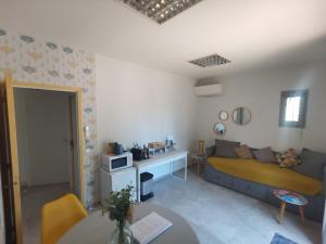 a living room with a bed and a table at La Chambre du Saunei in Castelnau-de-Guers