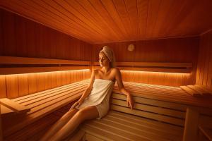 a woman is sitting in a sauna at Haus Sabine in Leutasch
