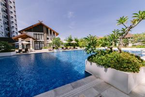 a pool at a resort with trees and a building at Royal Oceancrest Eleanor suites in Lapu Lapu City +103 photos