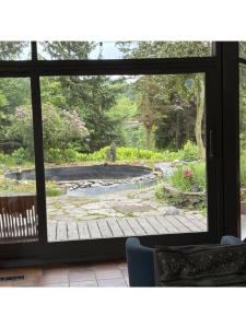 a view of a garden seen through a window at Domaine Heyen in Waimes +7 photos