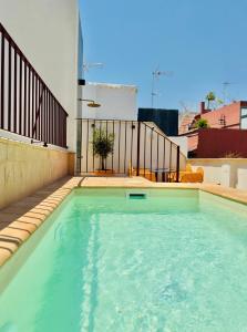 a swimming pool on the roof of a house at LIRIUM Casa Patio in Seville