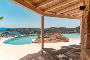 a view from the patio of a villa with a swimming pool at La Tiara di Cervo in Liscia di Vacca