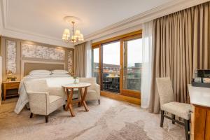 a bedroom with a bed and a table and chairs at Brooks Hotel in Dublin