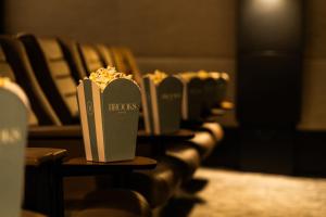 a row of seats with a box of popcorn at Brooks Hotel in Dublin +37 photos
