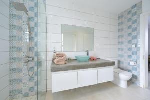 a bathroom with a sink and a toilet and a mirror at Villa Pur'Nam, 4 chambres, 5 min de la plage à pied in Cap Malheureux +43 photos