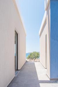 an empty hallway of a building with a view of the ocean at Blue Horizon in Palaiochóra