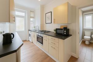 a kitchen with a sink and a stove top oven at Central Studio Apartment for 2 in Cardiff