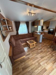a living room with a couch and a table at Mobil-Home in Castellane