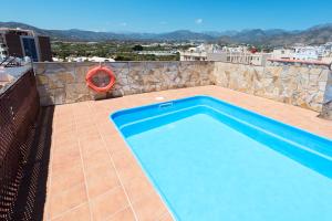 a swimming pool on the roof of a house at Hotel Toboso Chaparil in Nerja