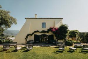 a group of chairs in front of a building at Casa Qafiz in Santa Cristina dʼAspromonte
