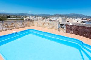a swimming pool on the roof of a building at Hotel Toboso Chaparil in Nerja
