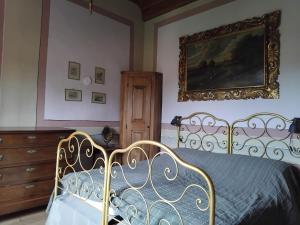 a bedroom with a bed and a dresser at All'Antico Convento in Cannero Riviera