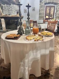a table with a white table cloth with food on it at Arcera AGRITURISMO in Piana di Forcella