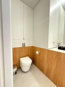 a bathroom with a toilet and a sink at Central & Modern Apartment in Banská Bystrica