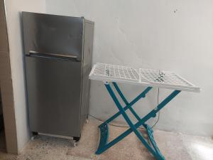 a small table next to a refrigerator in a room at Casa manolo in Fnidek