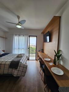 a bedroom with a bed and a table with two sinks at zyz centro in Sao Paulo