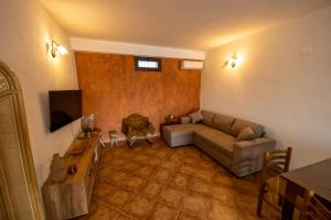 a living room with a couch and a table at Baia Marina Suite with private jacuzzi in Balestrate