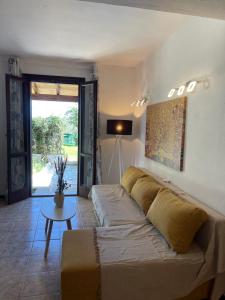 a living room with a couch and a table at Rastoni Apartments Skiathos in Troulos