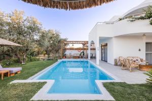 a swimming pool in the backyard of a house at Villa Bella Natura in Afantou