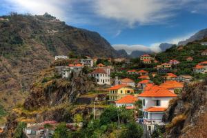 a village on a hill with houses on it at Hostel Casal São João in Ribeira Brava