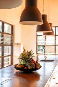 a bowl of fruit on a counter in a kitchen at Villa Kigali in Kigali