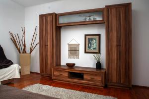 a large wooden entertainment center in a living room at U Ludwiki in Chmielno