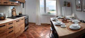 a kitchen with a table with dishes on it at U Ludwiki in Chmielno