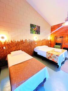 Ein Bett oder Betten in einem Zimmer der Unterkunft Pousada Pitauá