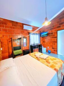 Ein Bett oder Betten in einem Zimmer der Unterkunft Pousada Pitauá