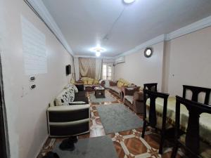 a living room with a couch and chairs in it at SUNRISE BLUE WAVE in Alexandria