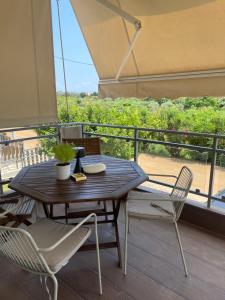 a table and chairs on a balcony with a view at Sea view villa in Preveza