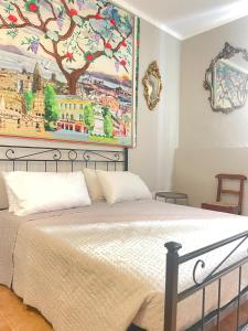 a bedroom with a bed with a painting on the wall at CASA FRE genova in Genova