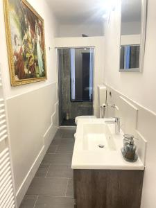 a white bathroom with a sink and a toilet at CASA FRE genova in Genova