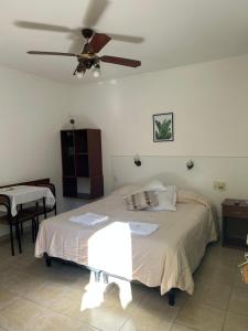 a bedroom with a bed with a ceiling fan at Bungalows Familys in Concepción del Uruguay