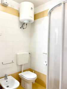 a bathroom with a toilet and a sink at Condominio Cam 78 in Lignano Sabbiadoro