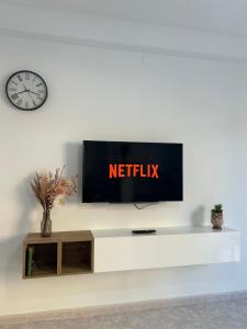 a tv on a white wall with a television at Alguer Zizì in Alghero