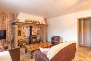 a living room with a wooden table and a fireplace at Gîte Chabrignac, jacuzzi et sauna privatif, piscine chauffée partagée, Wifi, salle de jeux in Beynat